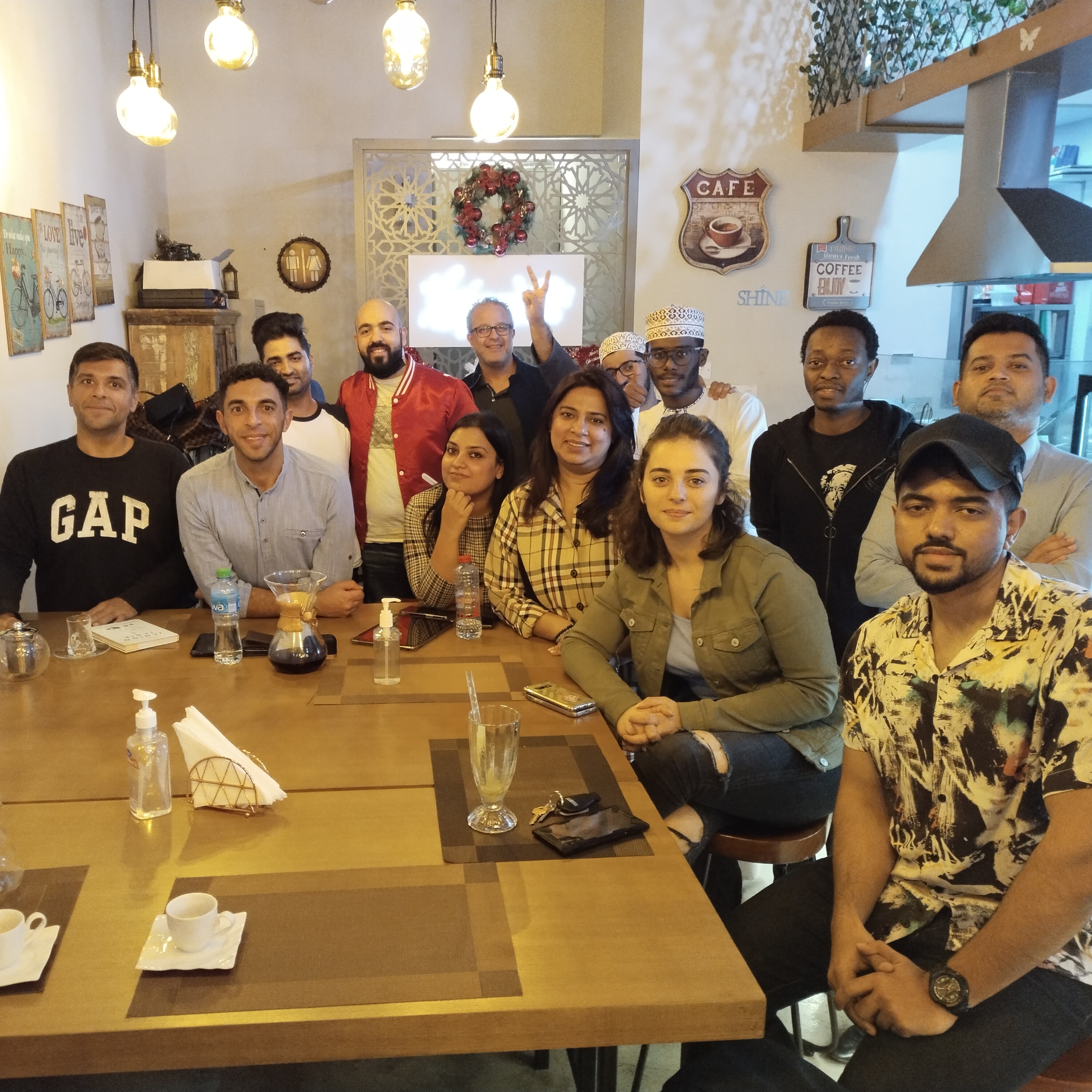 Large group photo in cafe setting